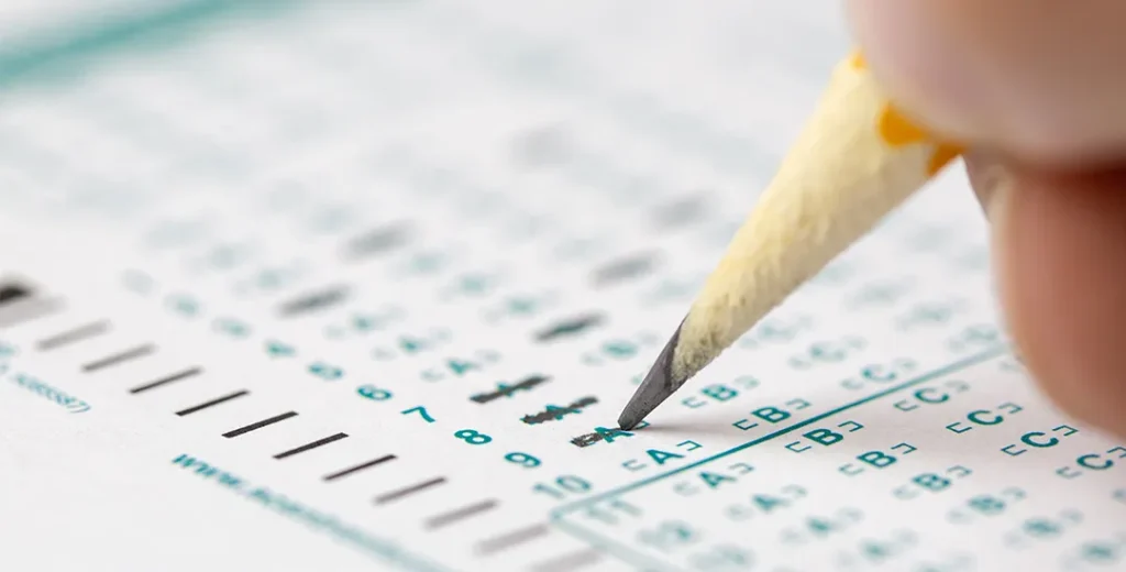 A student completes an AP Statistics test by marking their answer choices on the answer document.