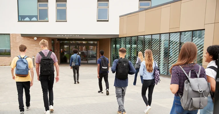 Teenage students entering a high school for an AP boot camp in summer school.