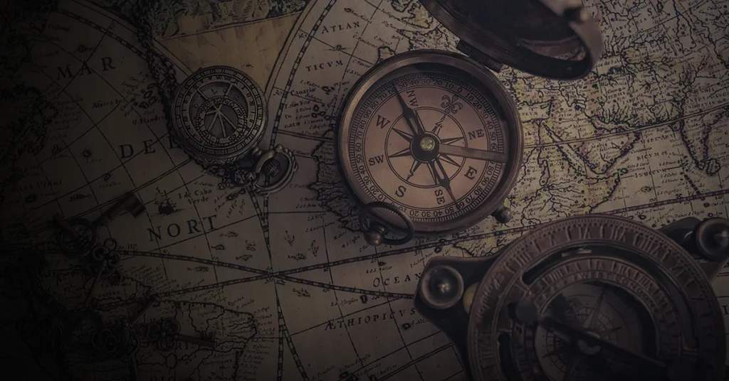 An old world map with antique compasses and keys represents history that spans across oceans and time.