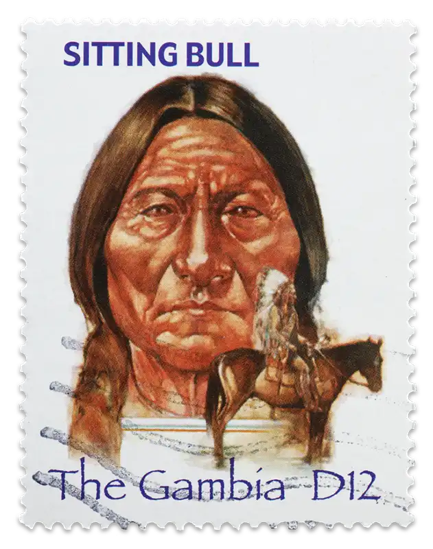 A vintage stamp with a portrait of Lakota Sioux Chief Sitting Bull shows his face and a profile of him sitting on a horse before the Wounded Knee Massacre that took his life.
