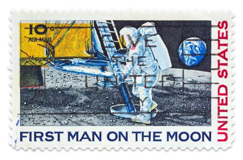A postage stamp shows Neil Armstrong setting foot on the moon in 1969.