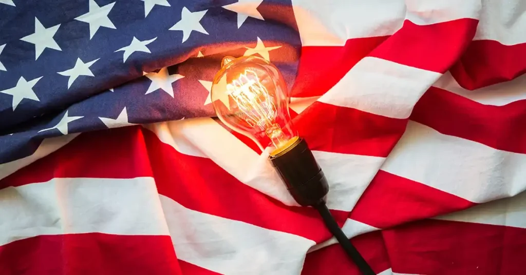 A light bulb rests upon a United States flag.