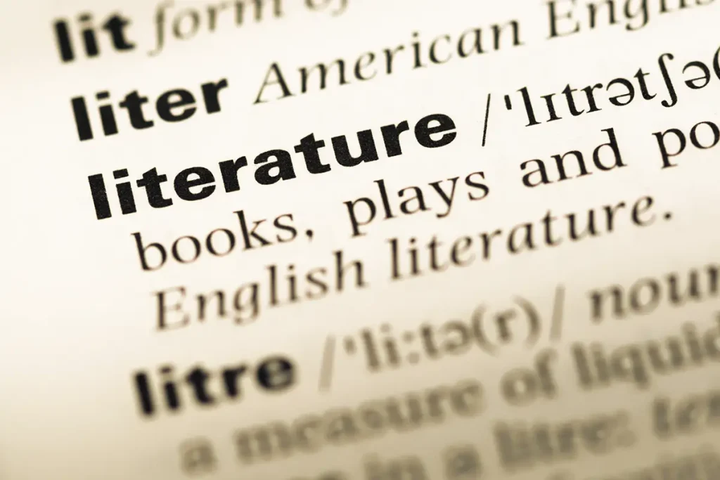 Close-up of an English dictionary page with the word literature.