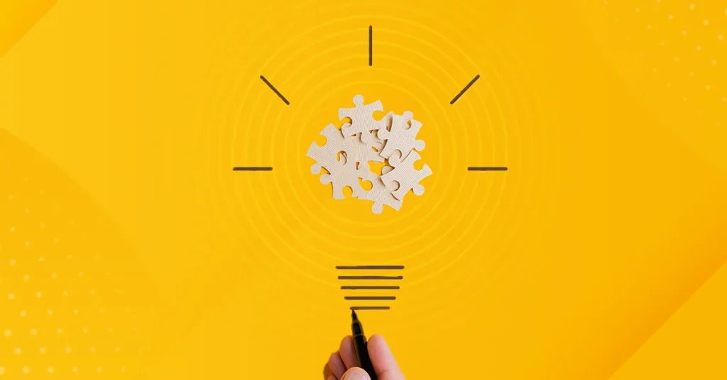 A light bulb over a yellow background represents putting puzzle pieces together to inspire student learning.