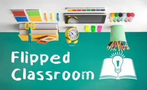 Classroom supplies sit upside down on an upside down desk in a visual representation of a flipped classroom.