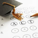 A scantron sheet and pencil with the letters A, C, and T and a graduation hat.