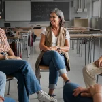 High school students engaging in a career discussion with their teacher.