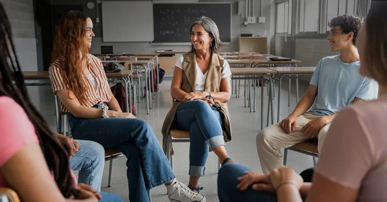 High school students engaging in a career discussion with their teacher.
